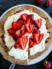 Strawberry vanilla cake with fresh strawberries and whipped cream.