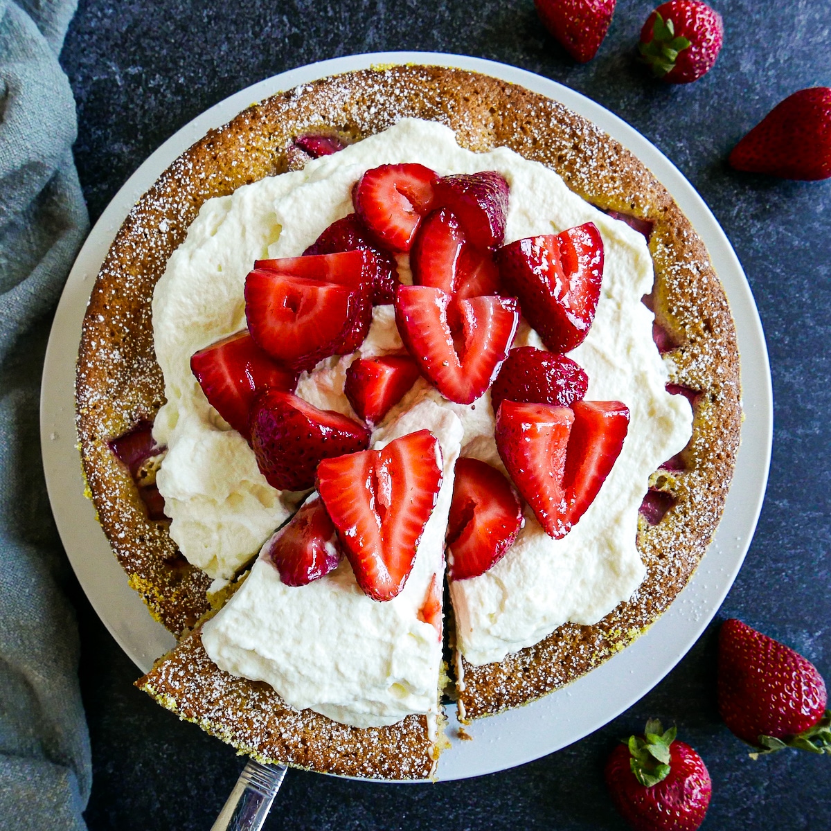 Strawberry vanilla cake with fresh strawberries and whipped cream.