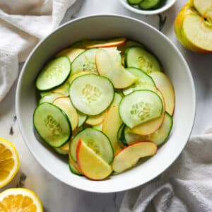 Crisp apple cucumber salad assembled in a bowl.