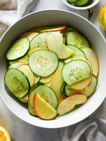 Crisp apple cucumber salad assembled in a bowl.