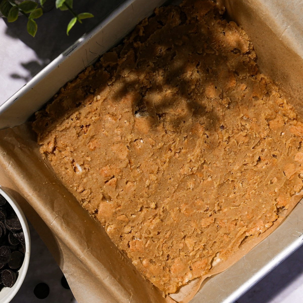 cookie-dough-in-pan.jpg Cookie dough with graham crackers pressed into pan.