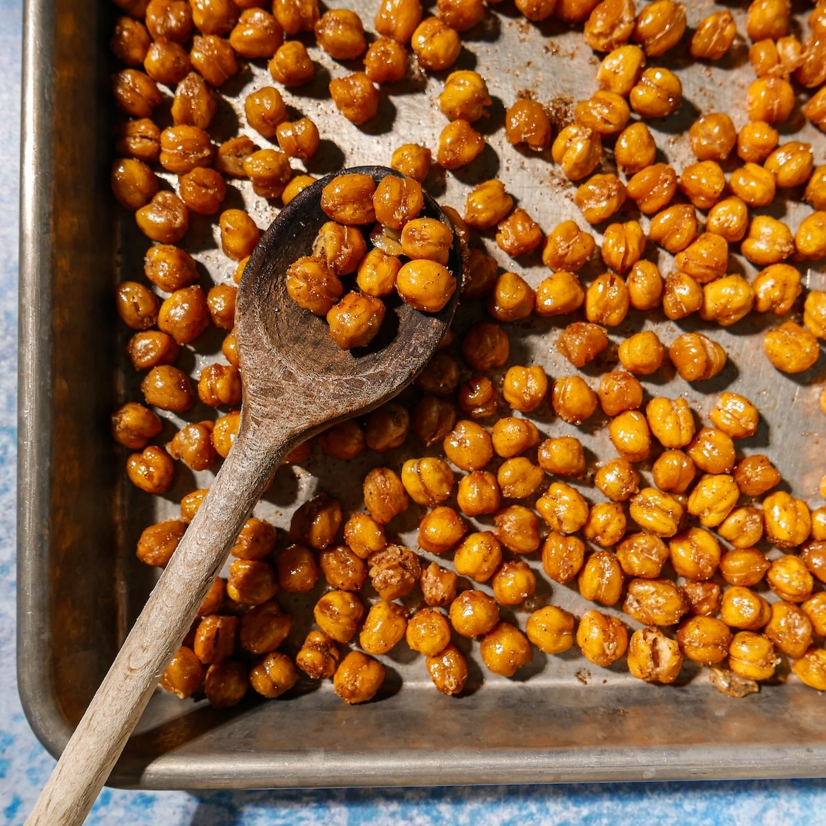 cumin-roasted-chickpeas.jpg Cumin roasted chickpeas on a baking sheet.