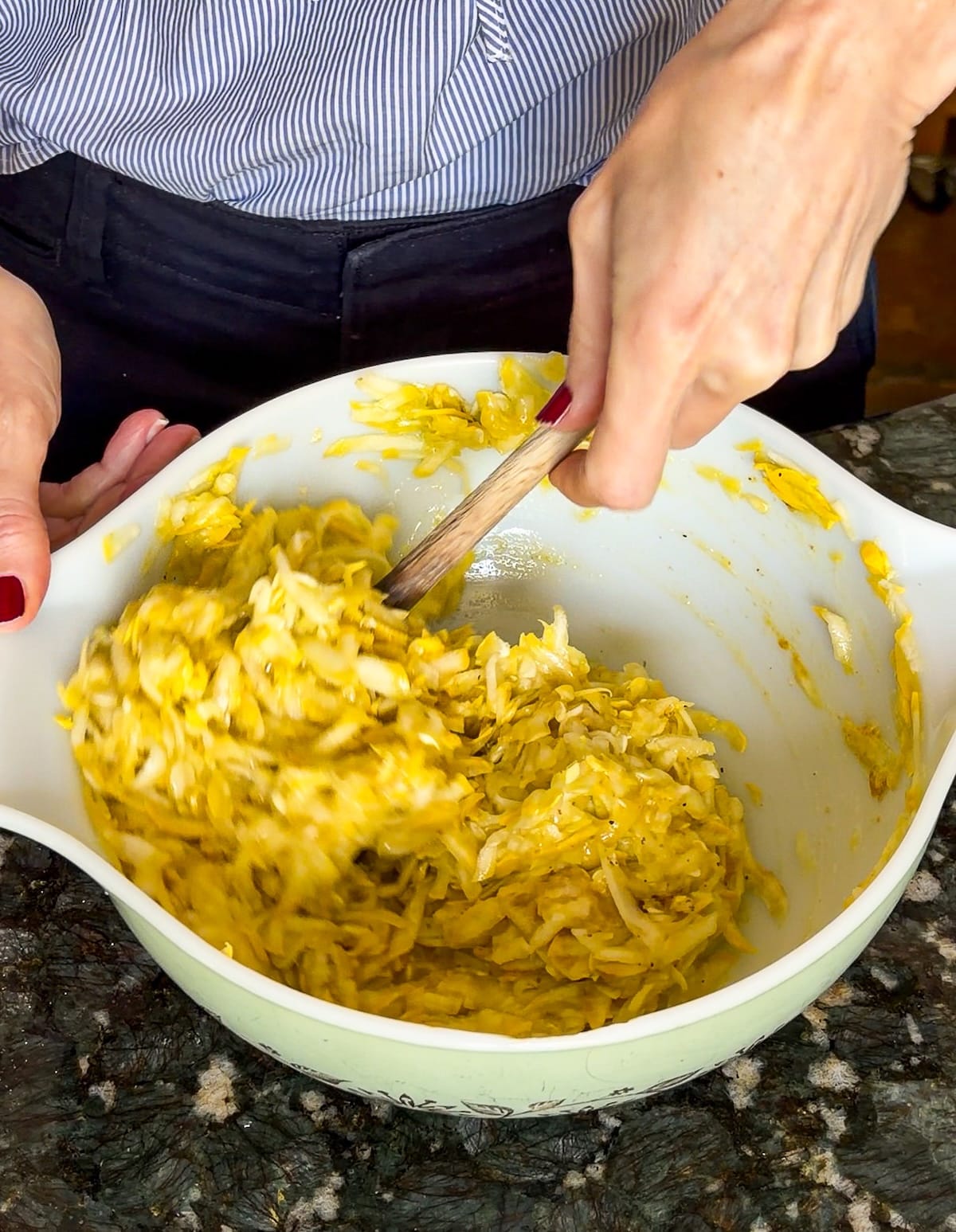 fritter-batter.jpg Mixing zucchini fritter batter together in a bowl.