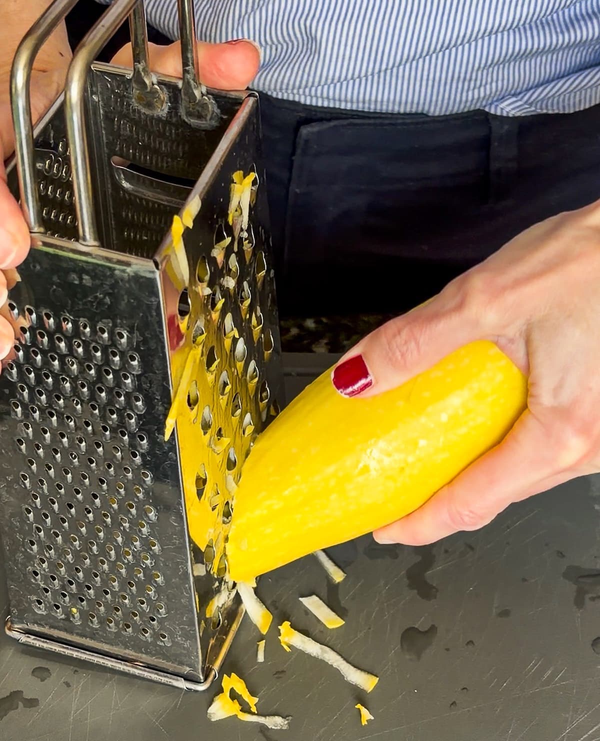 grated-zucchini.jpg Tossing grated zucchini with salt in a bowl.