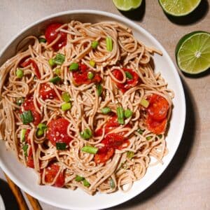 Cold soba noodle salad with roasted tomatoes and scallions.