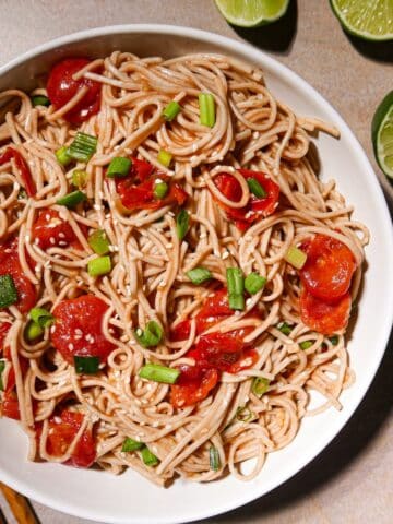 Cold soba noodle salad with roasted tomatoes and scallions.