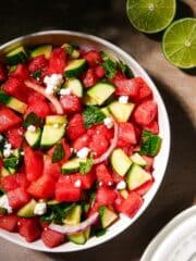 Watermelon and cucumber salad with feta and mint in a bowl.