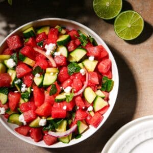 Watermelon and cucumber salad with feta and mint in a bowl.