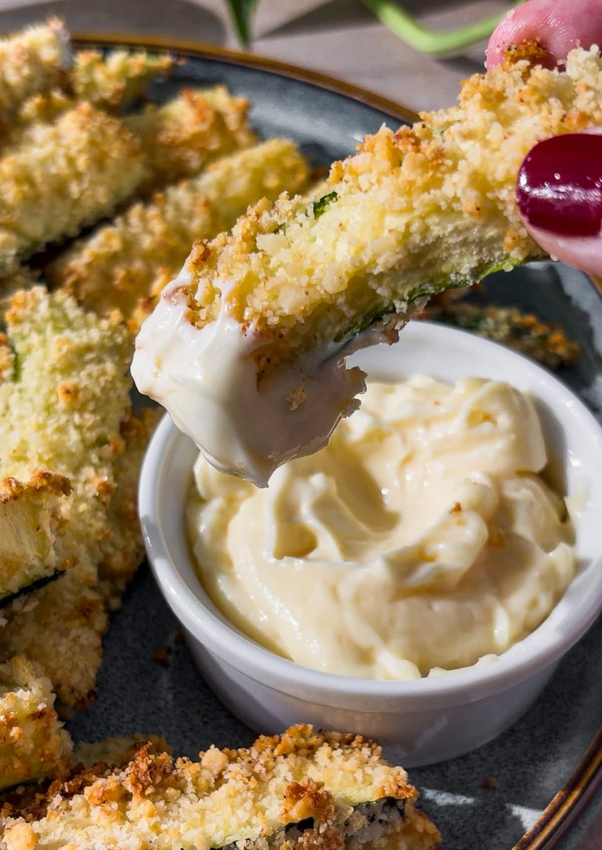 dipping-zucchini-fries.jpg Dipping baked zucchini fries in basil aioli.