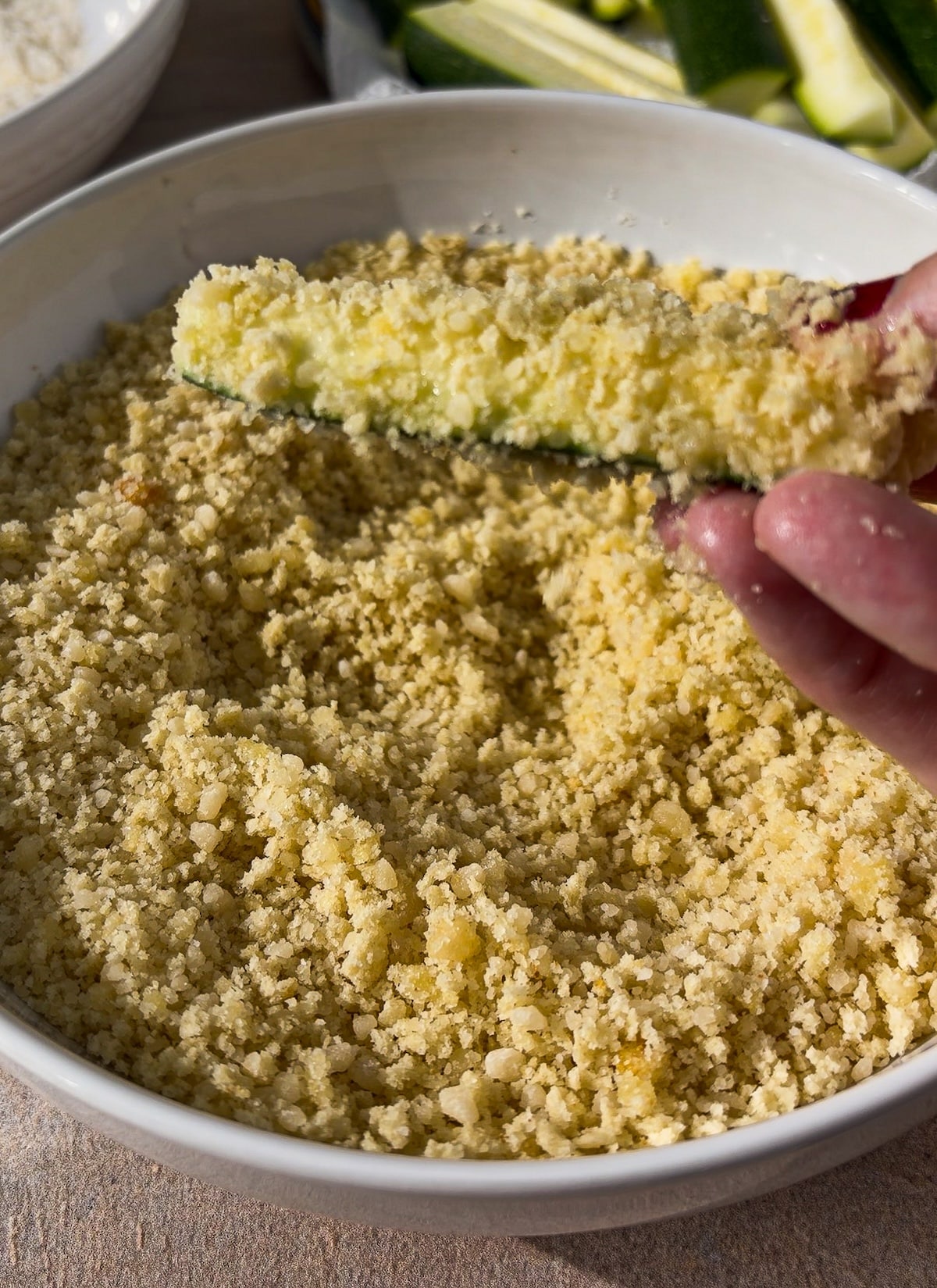 zucchini-in-panko-mixture.jpg Dredging zucchini in panko-Parmesan mixture.