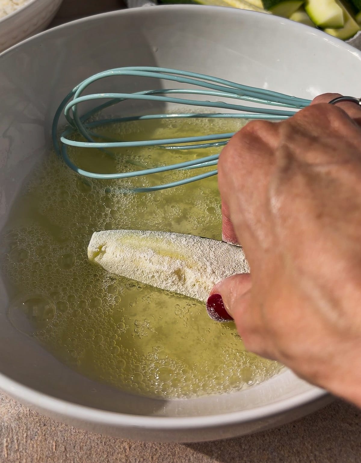 zucchini-in-egg-whites.jpg Dredging zucchini in egg whites.