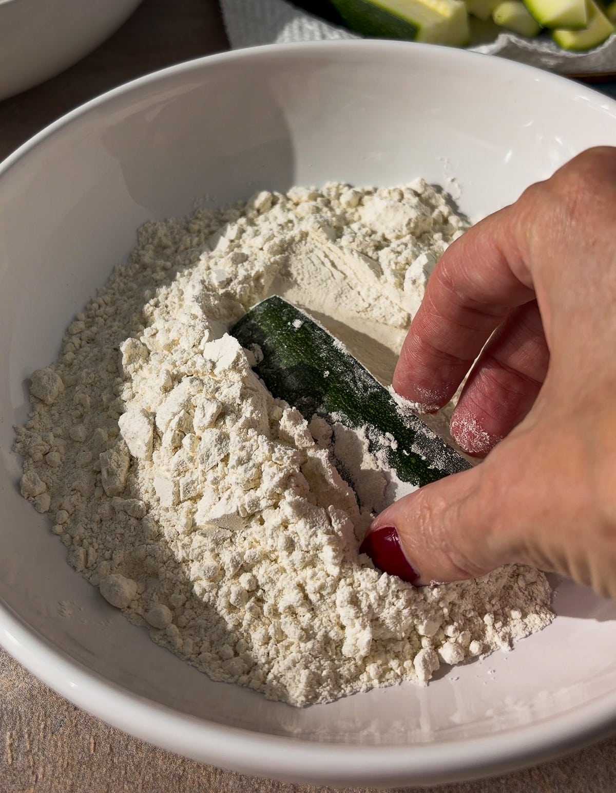 dredging-zucchini.jpg Dredging zucchini in flour.