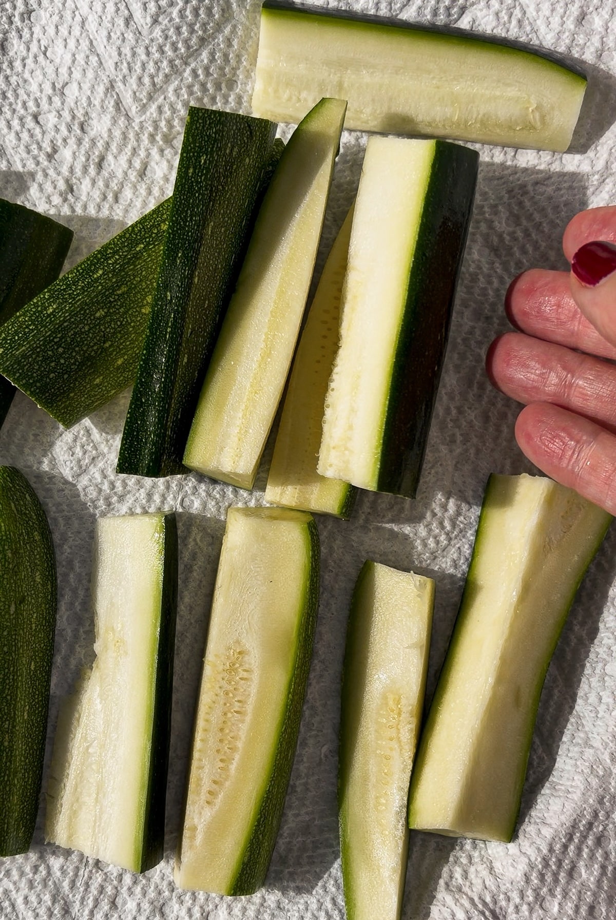 cut-zucchini.jpg Zucchini sticks arranged in an even layer.