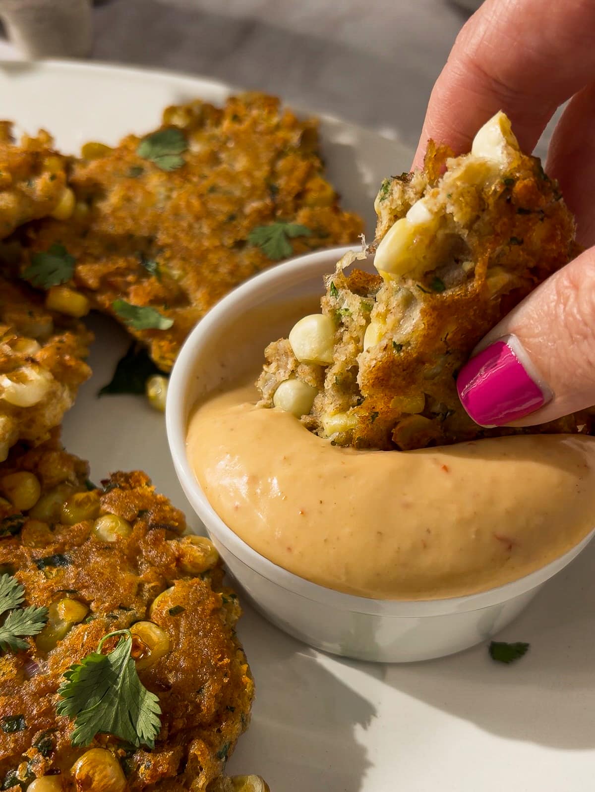 dipping-fritter.jpg Dipping fritter into sauce.
