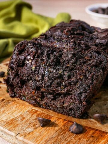 Double chocolate zucchini bread sliced with parchment paper.