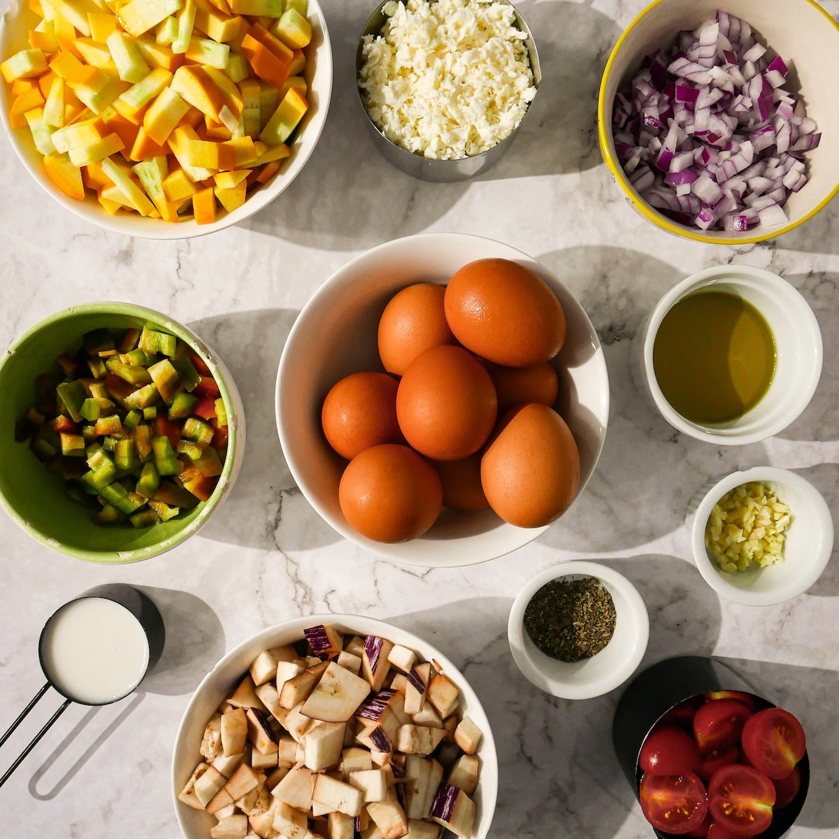 vegetarian-frittata-ingredients.jpg Vegetarian frittata ingredients on a table.