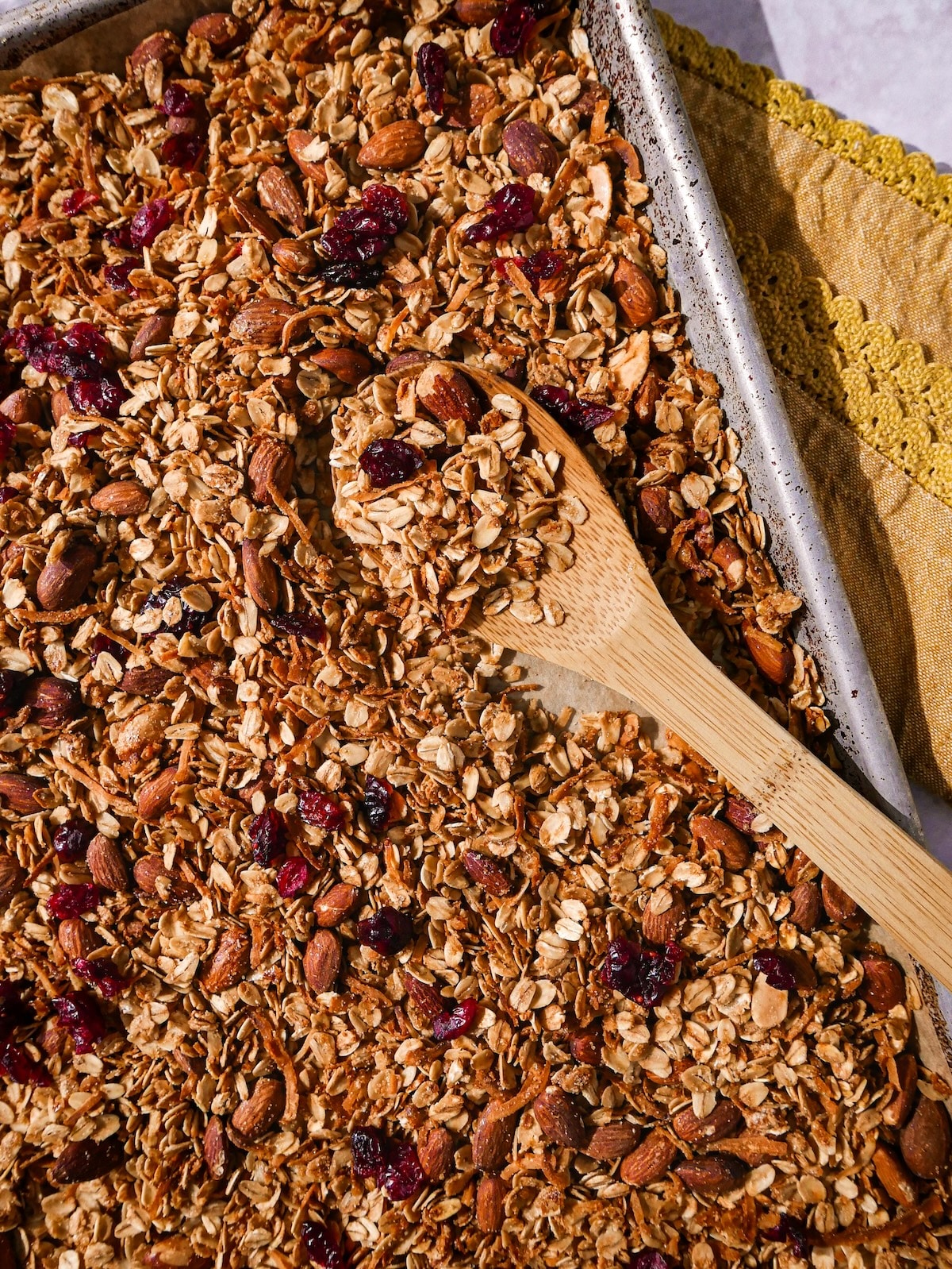 baked-granola.jpg Baked homemade granola with wooden spoon.