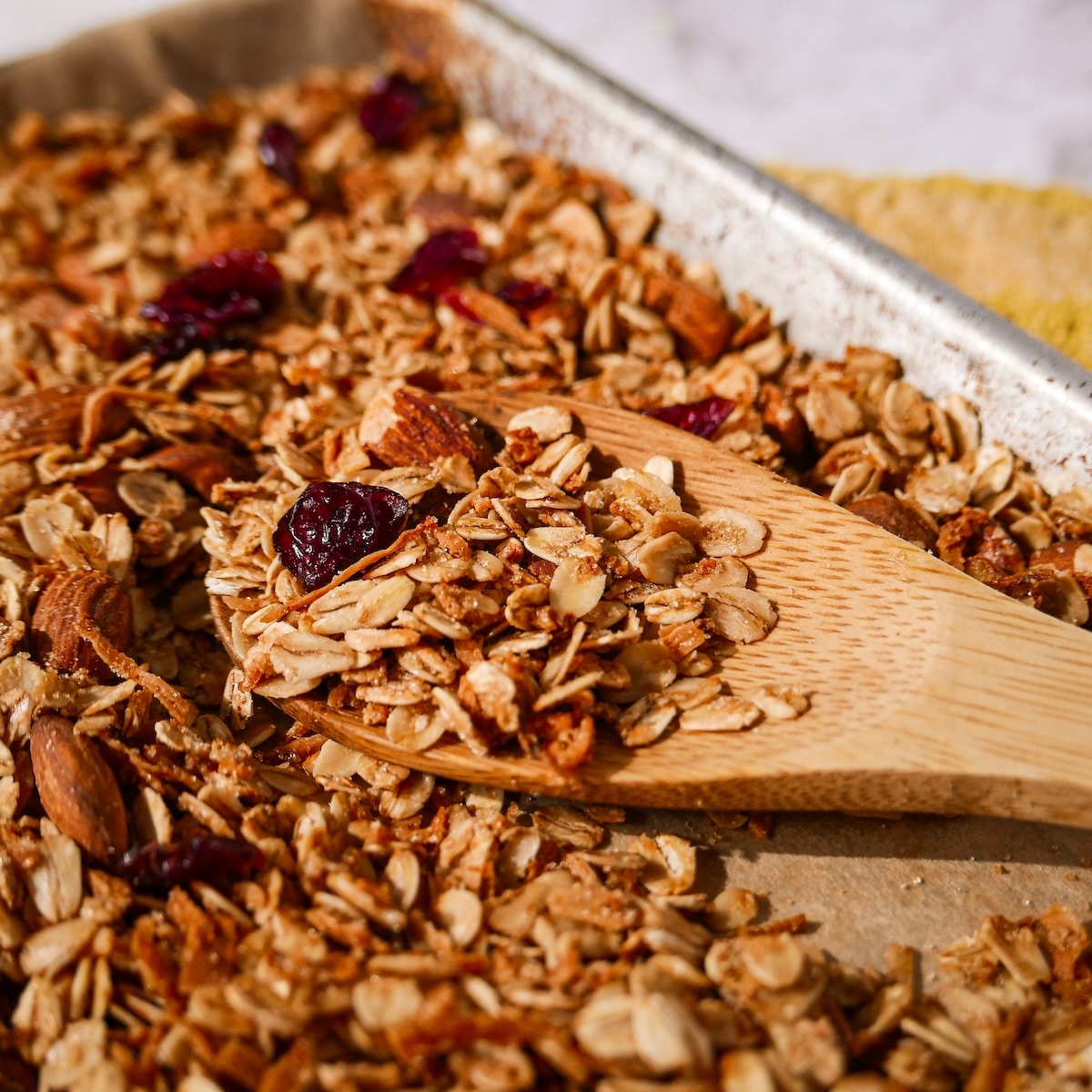 Crisp homemade granola on a baking sheet.