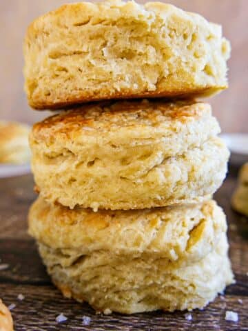 Flaky buttermilk biscuits on a cutting board.