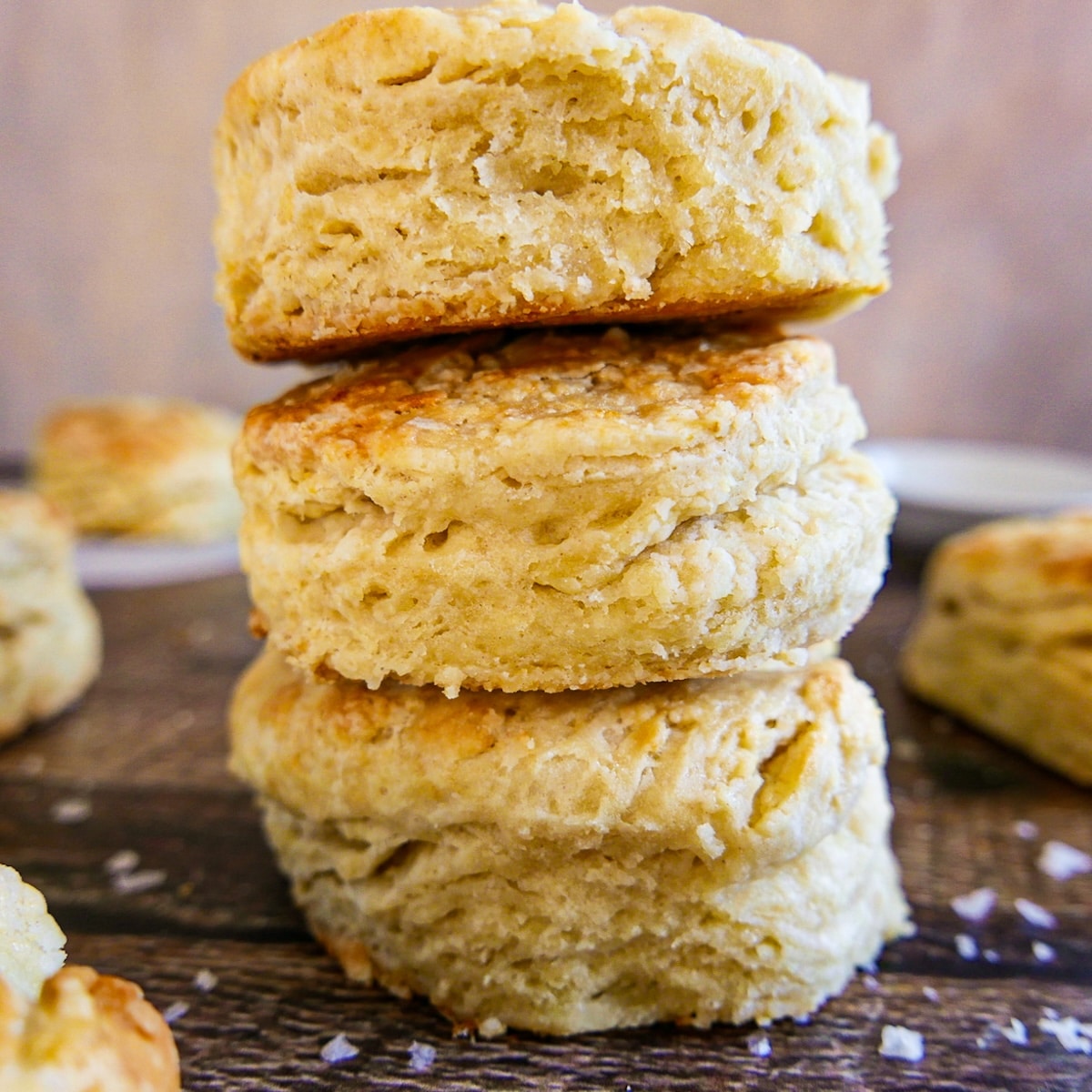 Flaky buttermilk biscuits on a cutting board.