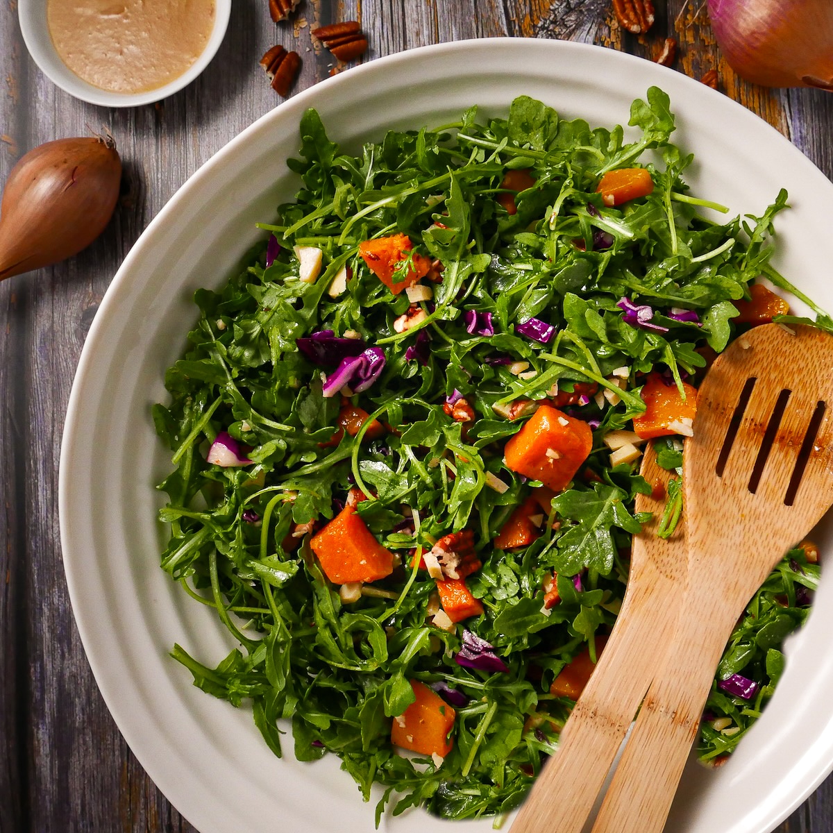 winter-squash-salad.jpg Winter squash salad with dressing and two serving spoons.