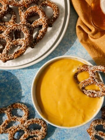Bowl of creamy pretzel cheese dip with cheddar cheese.
